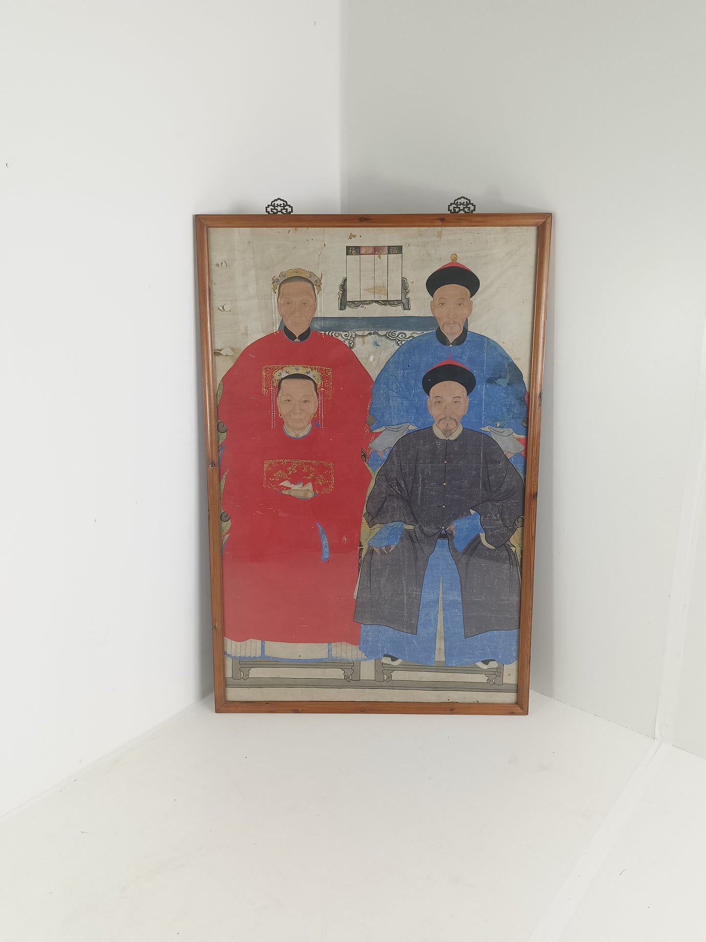 A framed Chinese ancestral portrait is a traditional hand-painted