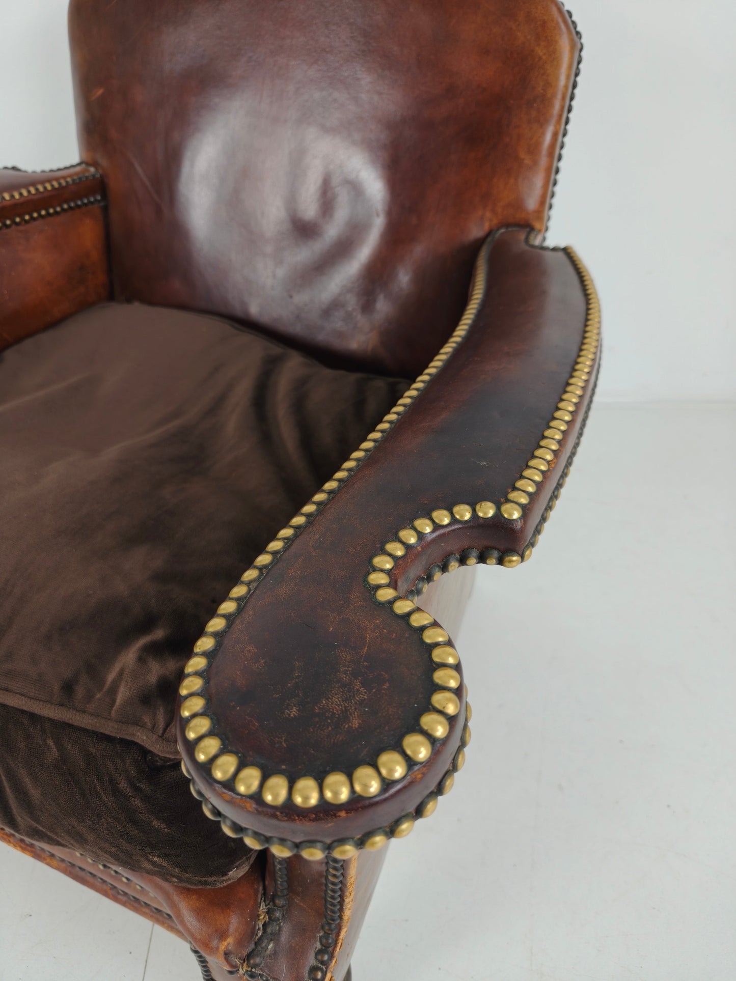 Antique Leather Club Chair with Stud Detailing Antique Leather Club Chair with Stud Detailing