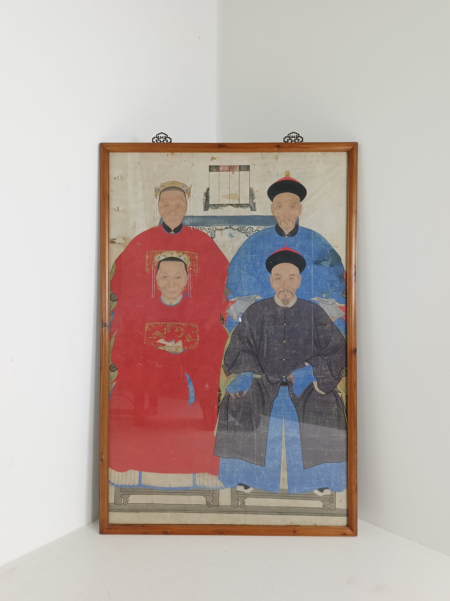 A framed Chinese ancestral portrait is a traditional hand-painted