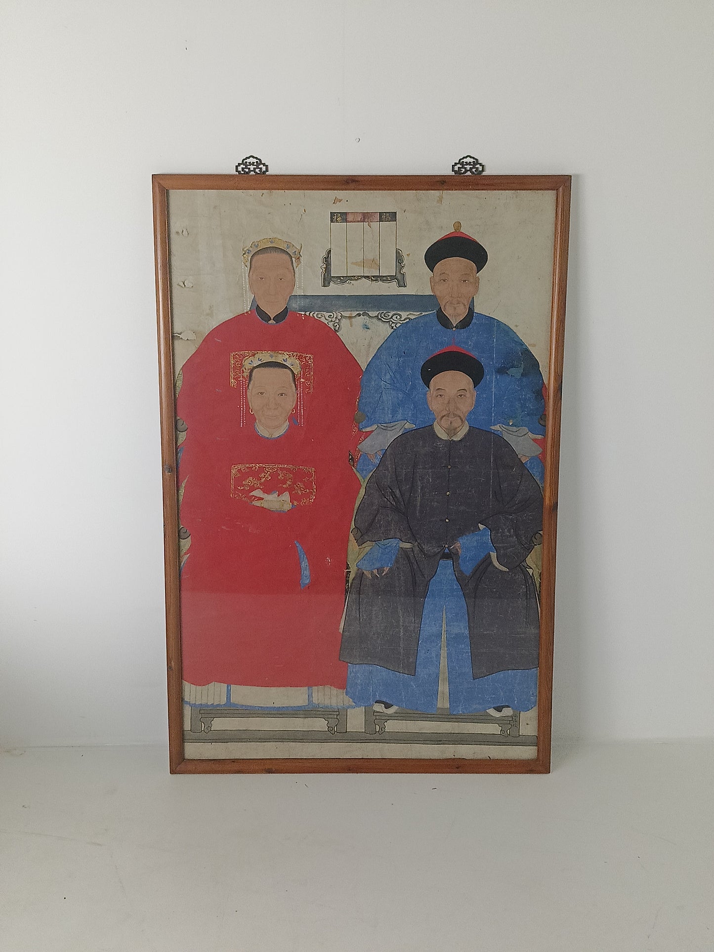 A framed Chinese ancestral portrait is a traditional hand-painted