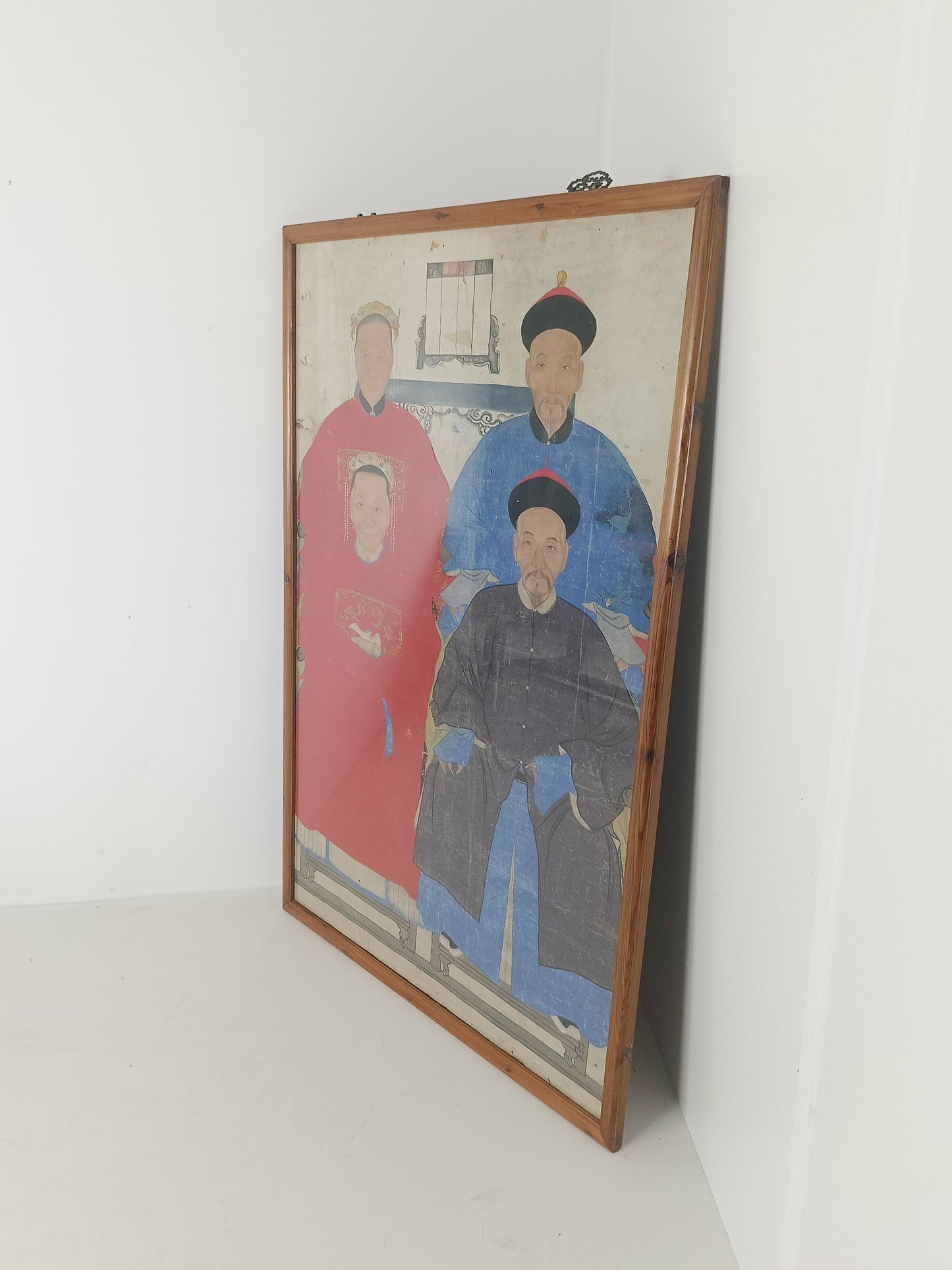 A framed Chinese ancestral portrait is a traditional hand-painted