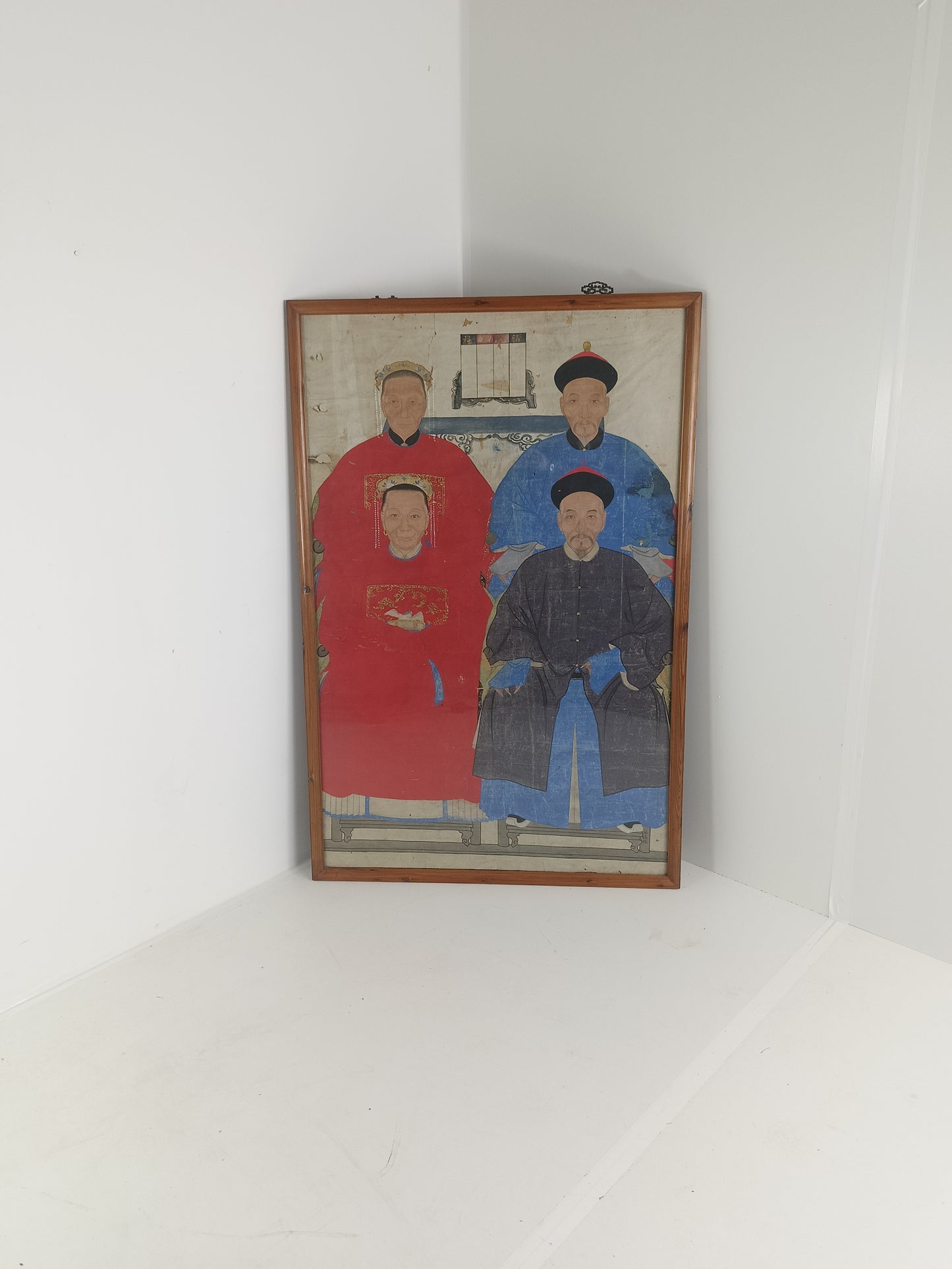 A framed Chinese ancestral portrait is a traditional hand-painted