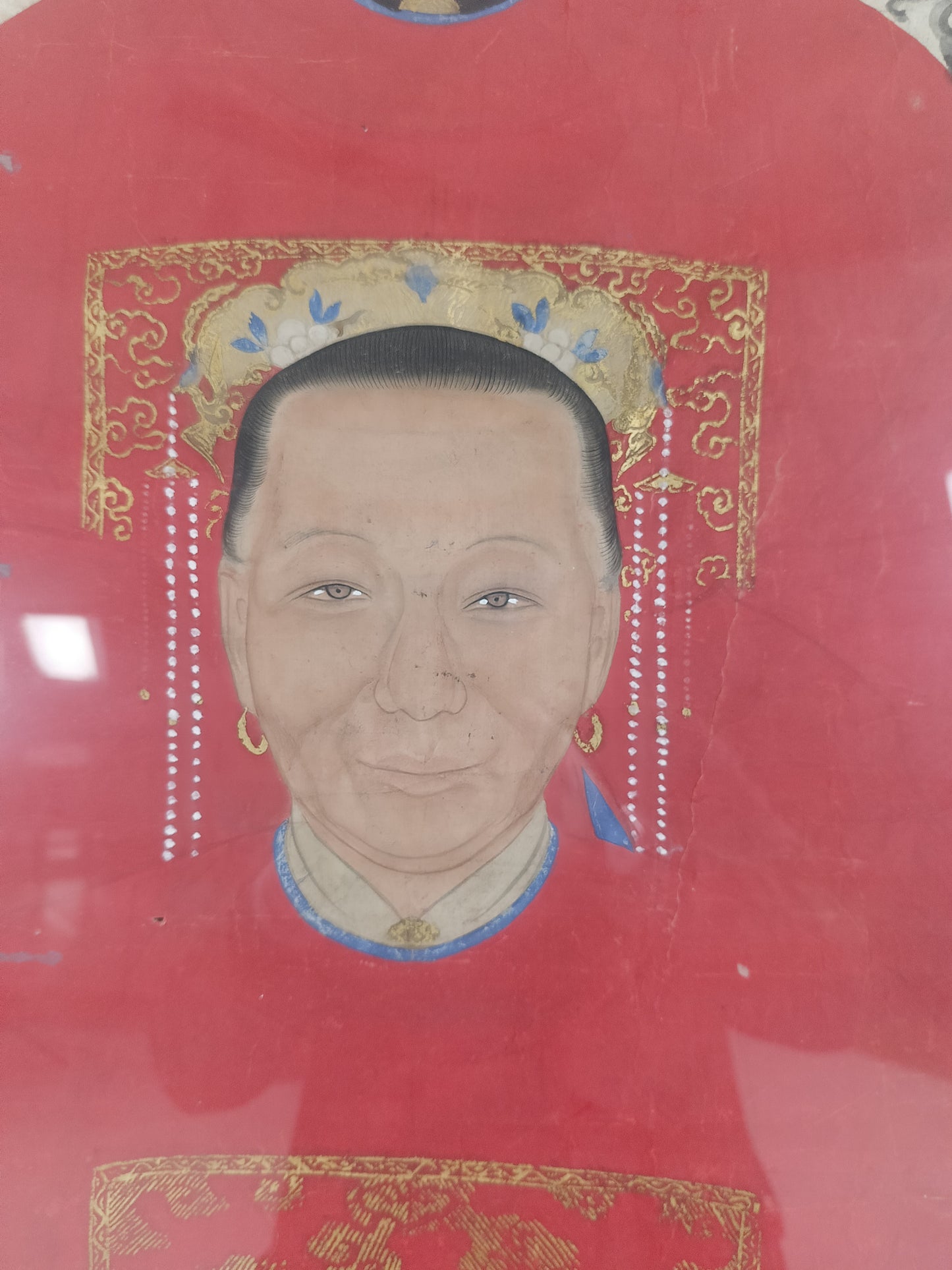 A framed Chinese ancestral portrait is a traditional hand-painted