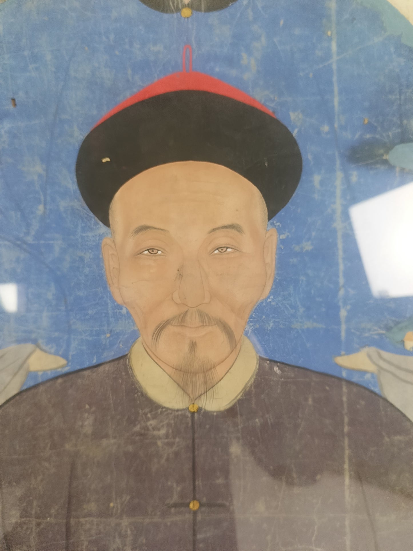 A framed Chinese ancestral portrait is a traditional hand-painted