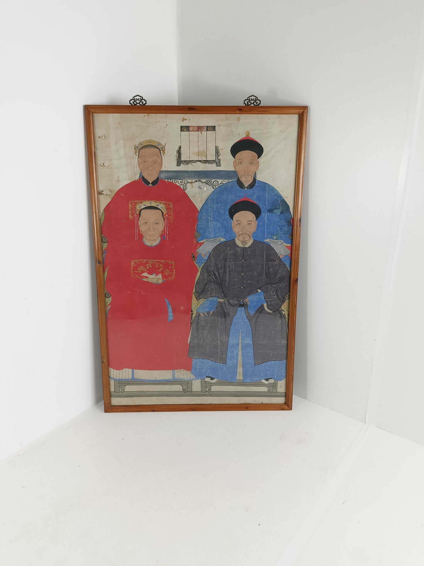 A framed Chinese ancestral portrait is a traditional hand-painted