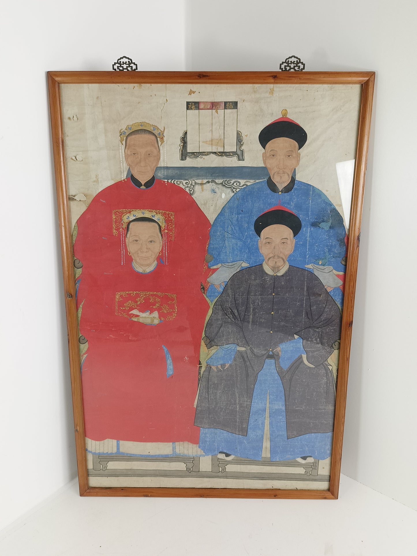 A framed Chinese ancestral portrait is a traditional hand-painted