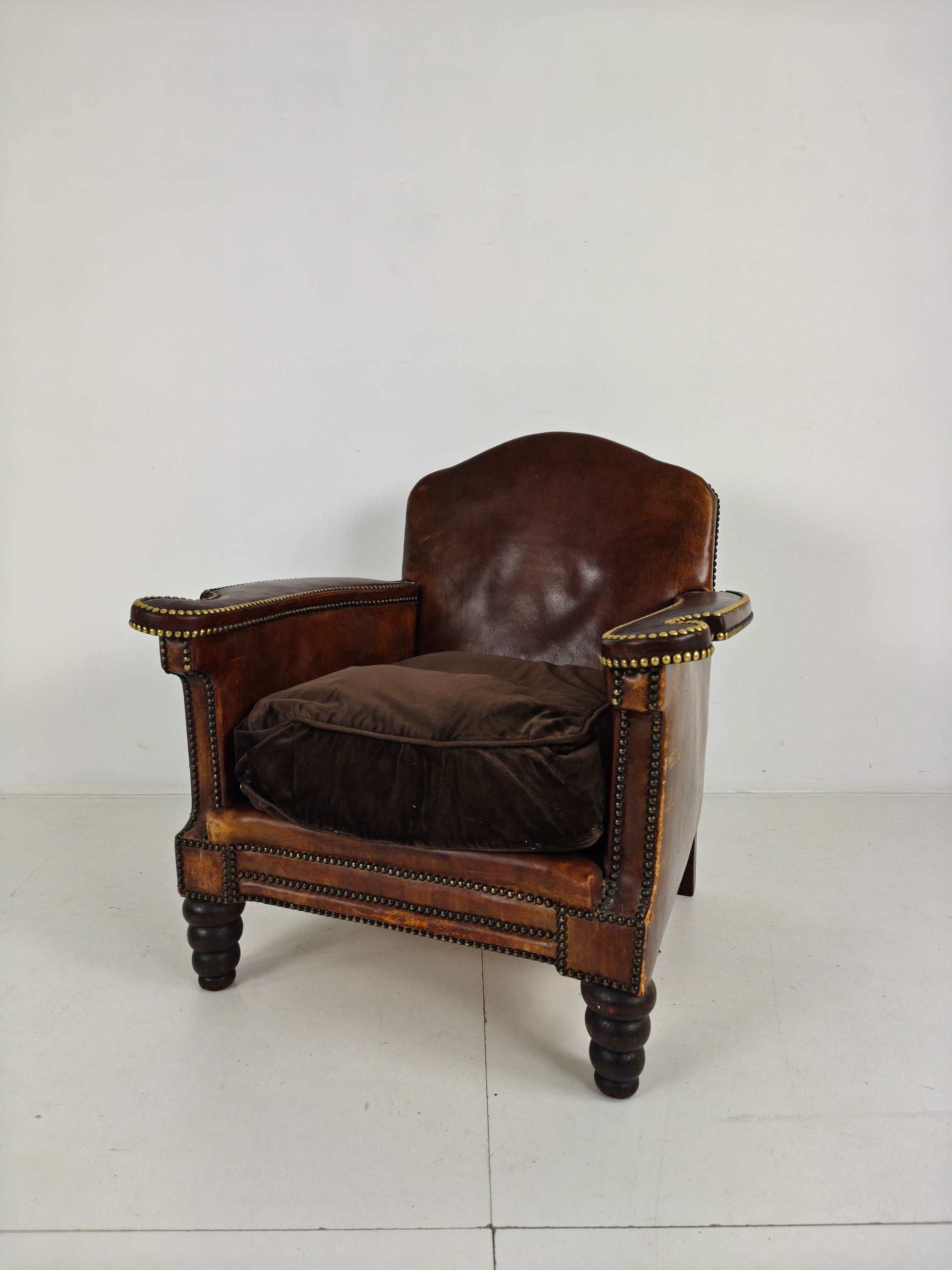 Antique Leather Club Chair with Stud Detailing Antique Leather Club Chair with Stud Detailing